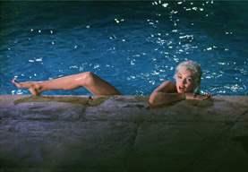 Marilyn Monroe 1962 climbing from pool by Lawrence Schiller